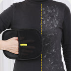The black pet grooming glove being wiped across a dark knitted jumper